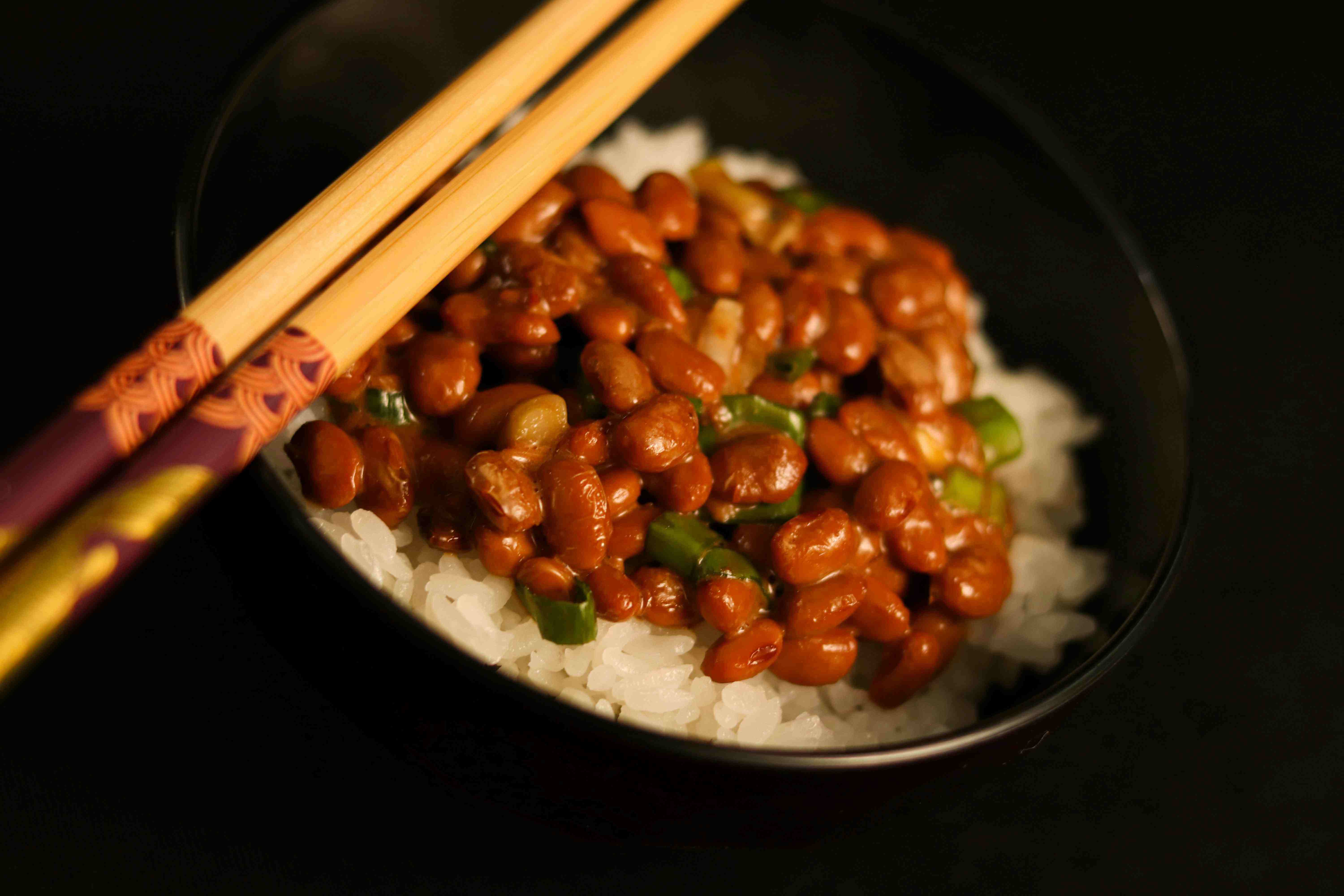 Close-up of naturally fermenting brown rice in a rustic bowl, soft natural light, evoking warmth and wellness.&nbsp;