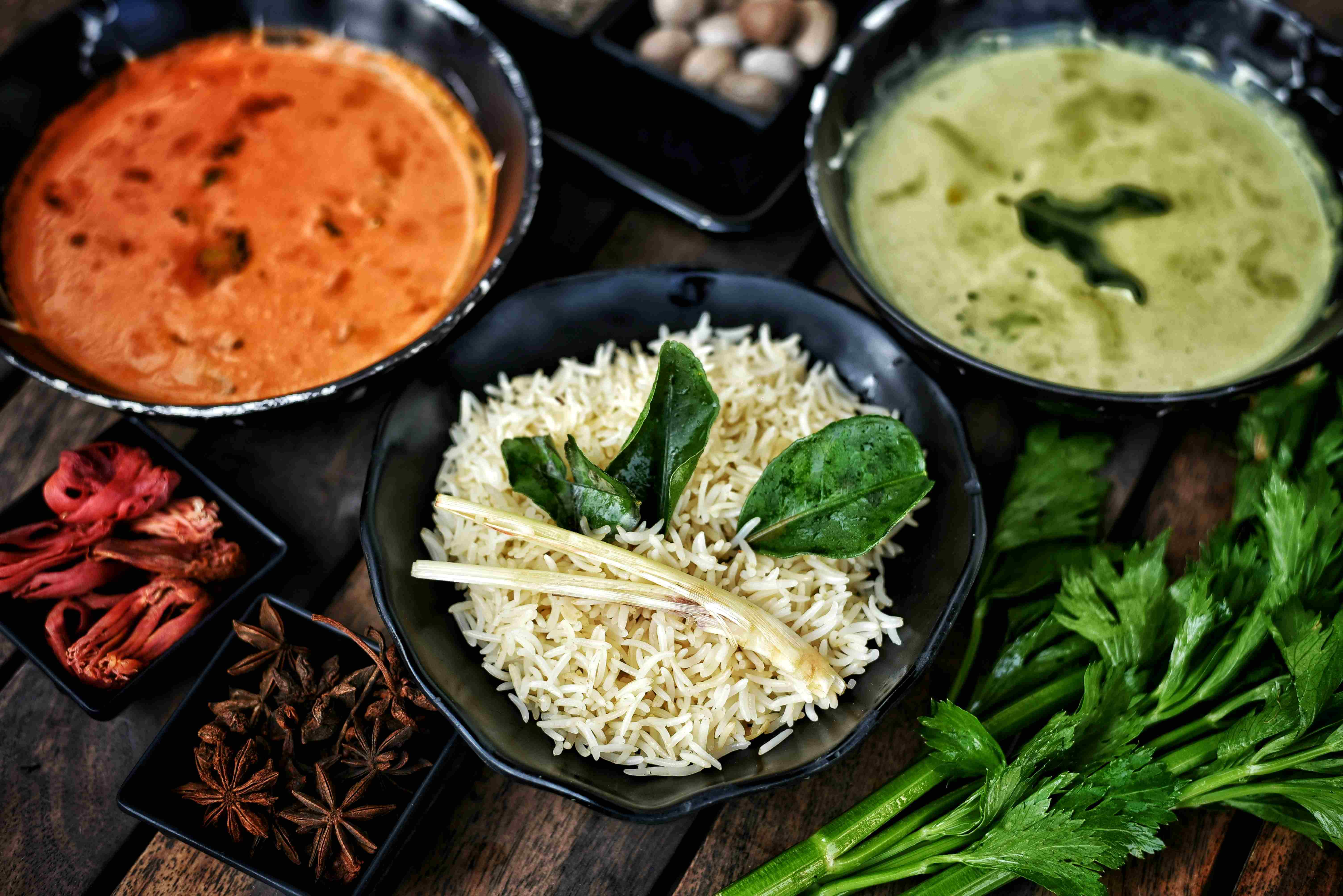 Warm table setting with fermented rice dishes and spices, soft natural lighting.&nbsp;