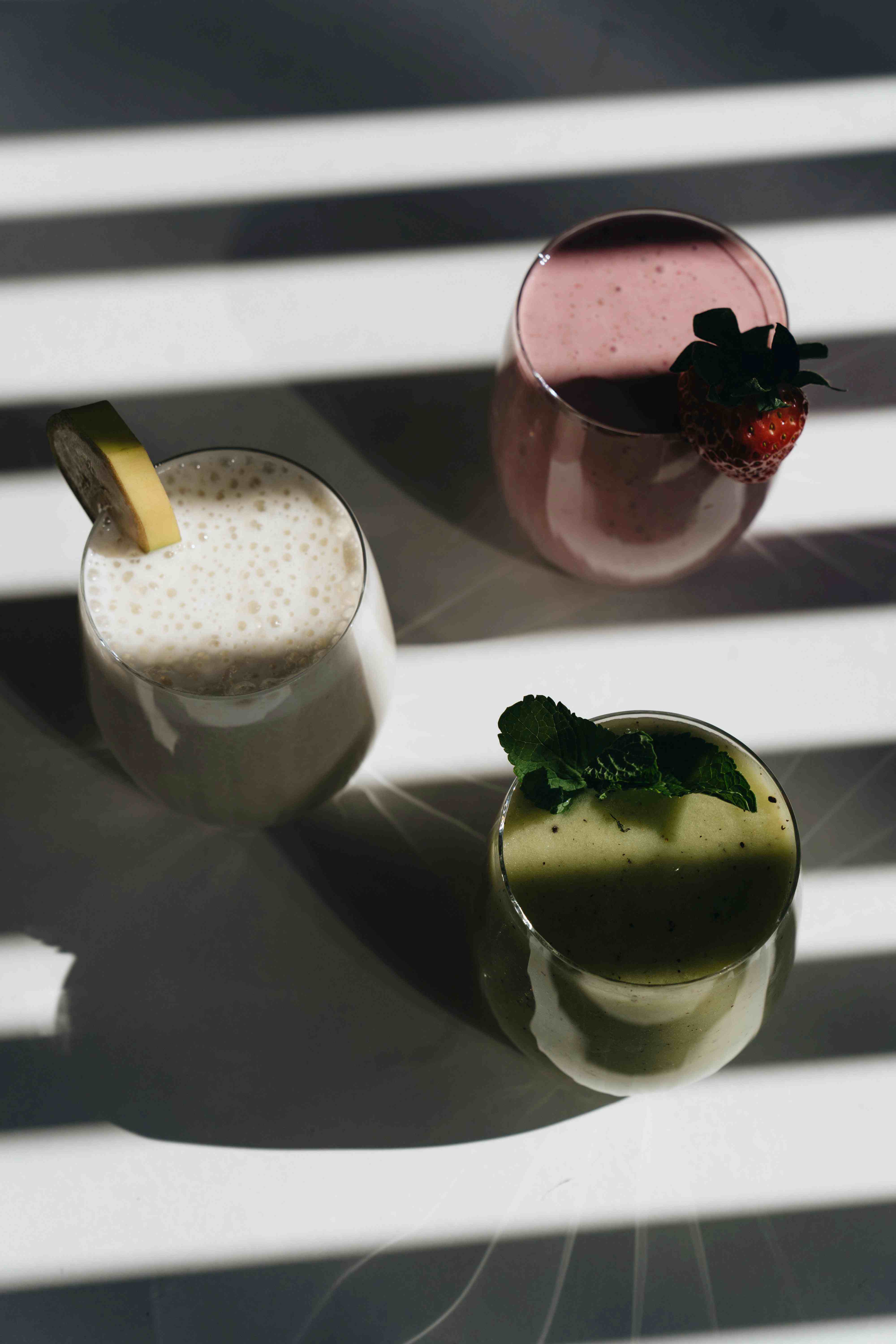 Calm morning scene of someone blending a smoothie with plant-based protein powder.&nbsp;